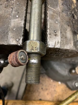 Use a dremel to create a flat spot where you want the hole.