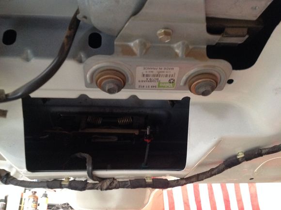 The little red piece is where the strap attaches.  Pulling up at that point releases the latch