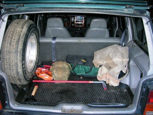 Factory rubber flooring in back plus a protective removeable tray from the Bone-yard