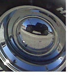 short jeep reflection of hubcap on a T-bucket roadster