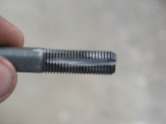 Find a same size bolt as the seat belt bolt. Cut a groove onto it and use it to make or cut the treads on the upper hole on the frame. The bolt is a fine tread bolt.
