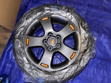 Painted stock wheels about $60 mod $18 for the graphite $19 for the clear coat $19 for the metallic orange .