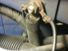 Here’s the one on the rad cradle , look on the drivers side of the engine bay above the headlight. 
The other end is on the transmission housing just down to the right of the oil filter cap. 