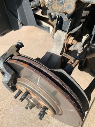 See the splash shield is touching the rotor, check the caliper slide pins , they should move easily in the caliper bracket 
