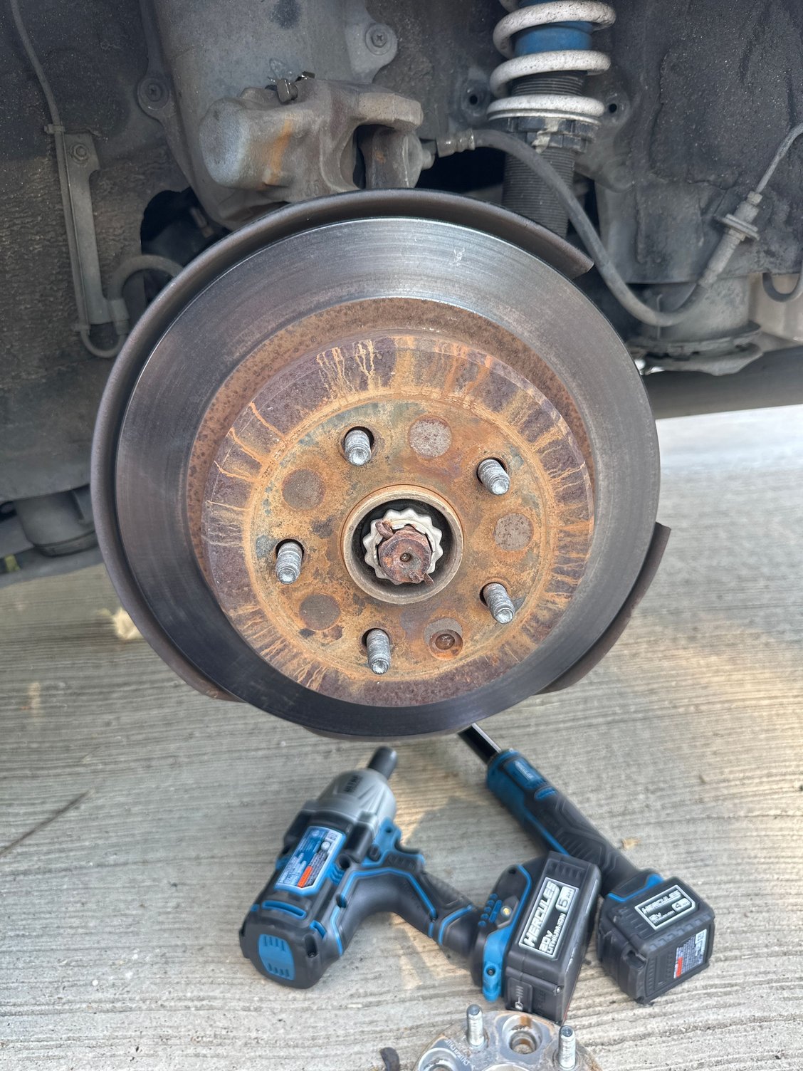 Unfortunately the rotor makes it inaccessible to get to the parking brake adjustment lol