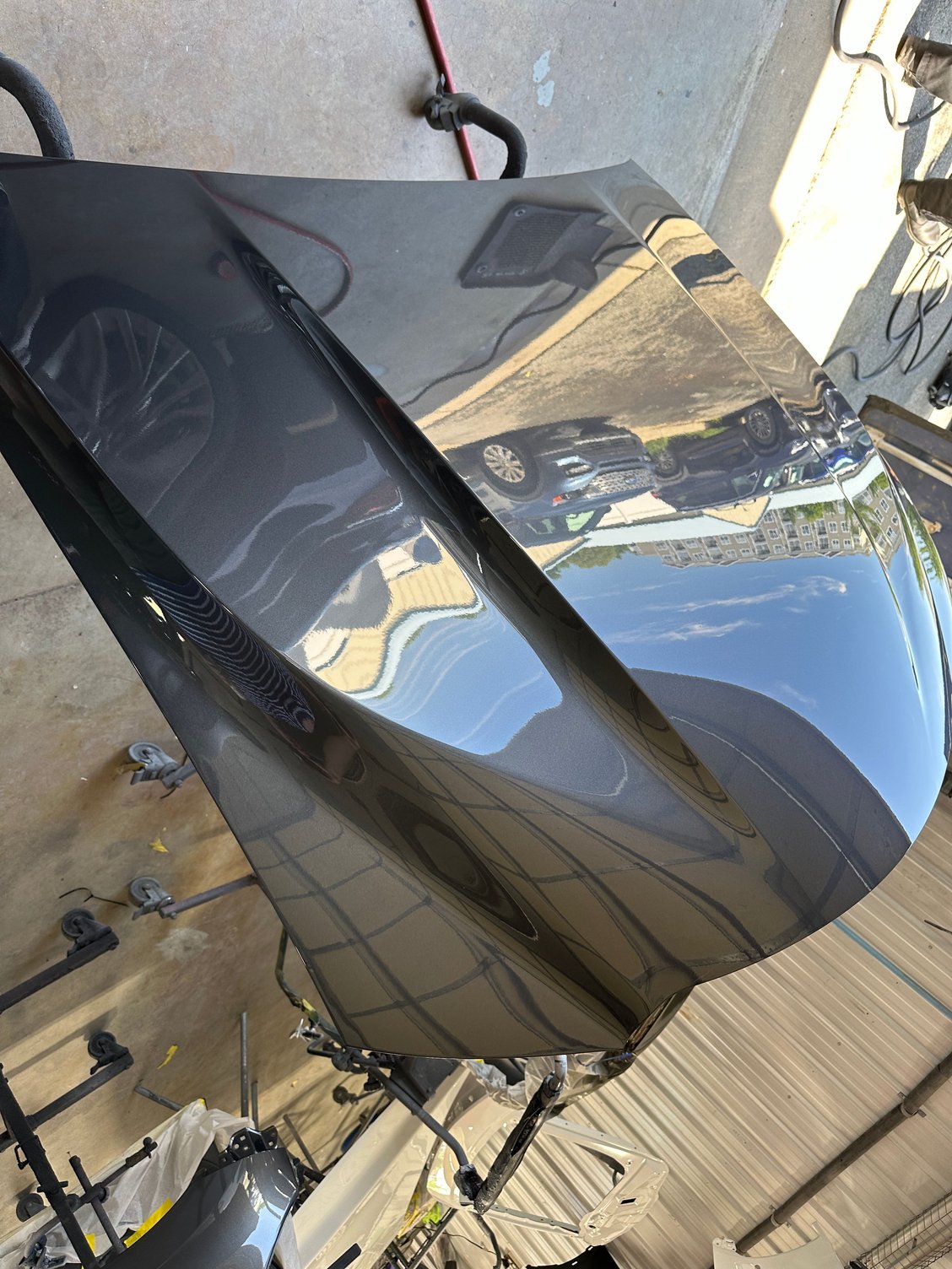 New IS500 hood just after new Cloudburst Gray paint.  Hood is being wet-sanded and buffed.
