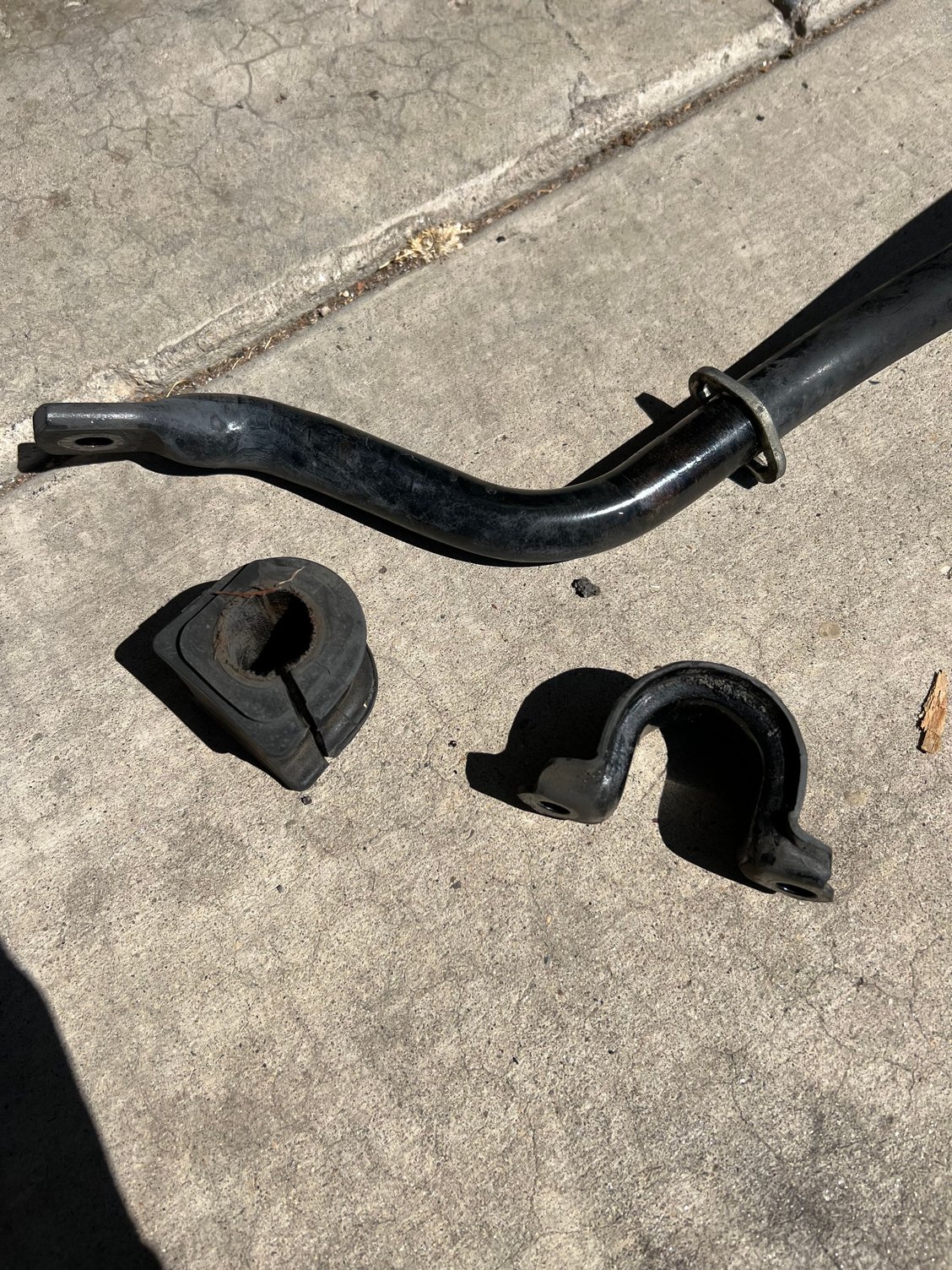 Off comes the bushing from the sway bar and bracket. You will reuse the bracket