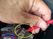 Red wire goes to camera trigger on voltage...or said another way.  It is the 12v from the backup lights and this wire is connected to the camera.
In your case, you may need this power to go to the blue wire on your NAVICS