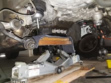 The engine is supported by 2 jacks. Use carpet and wood to distribute the load on the oil pan.