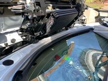 Turns out this location is perfect!  Th bottom has to clear the two black bumpers at the bottom that the window frame rests on.   It has to go in front of the sliver bar, to allow clearance for the rear deck to pivot.  Right where it is, it clears everything fine.   I'll flip it over, so that it's not upside down.