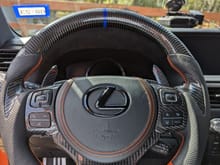 Orange leather flat bottom, black perforated leather sides, carbon fiber thumb grips + top half, CF trim replacements, new airbag cover with matching stitching.