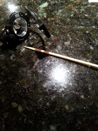 Wooden skewer stick used to apply and smooth foil to bulb assembly cavity