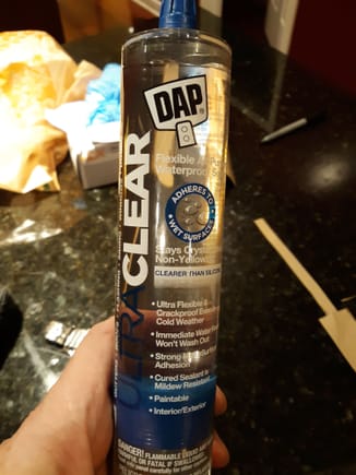 Used Dap clear rubberized sealer between the plastic map pocket and backside of door panel.

This adhesive sets quickly and has enough surface energy to work between the hard plastic and pressboard door card.


Should disassembly be required in the future, then the rubber can be easily scored.

