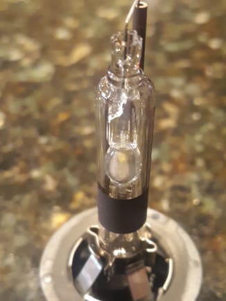 A close-up shot of the glass envelope  of original Phillips bulb lacks the clairity of the new bulb.