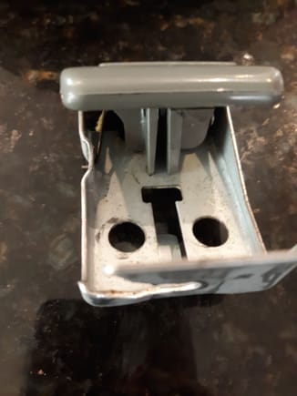 Backside of hood release handle depicts where plastic handle slams into metal mounting bracket. 