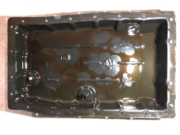 Bottom of the pan with magnets filled with sludge