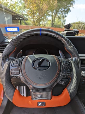 Orange leather flat bottom, black perforated leather sides, carbon fiber thumb grips + top half, CF trim replacements, new airbag cover with matching stitching.