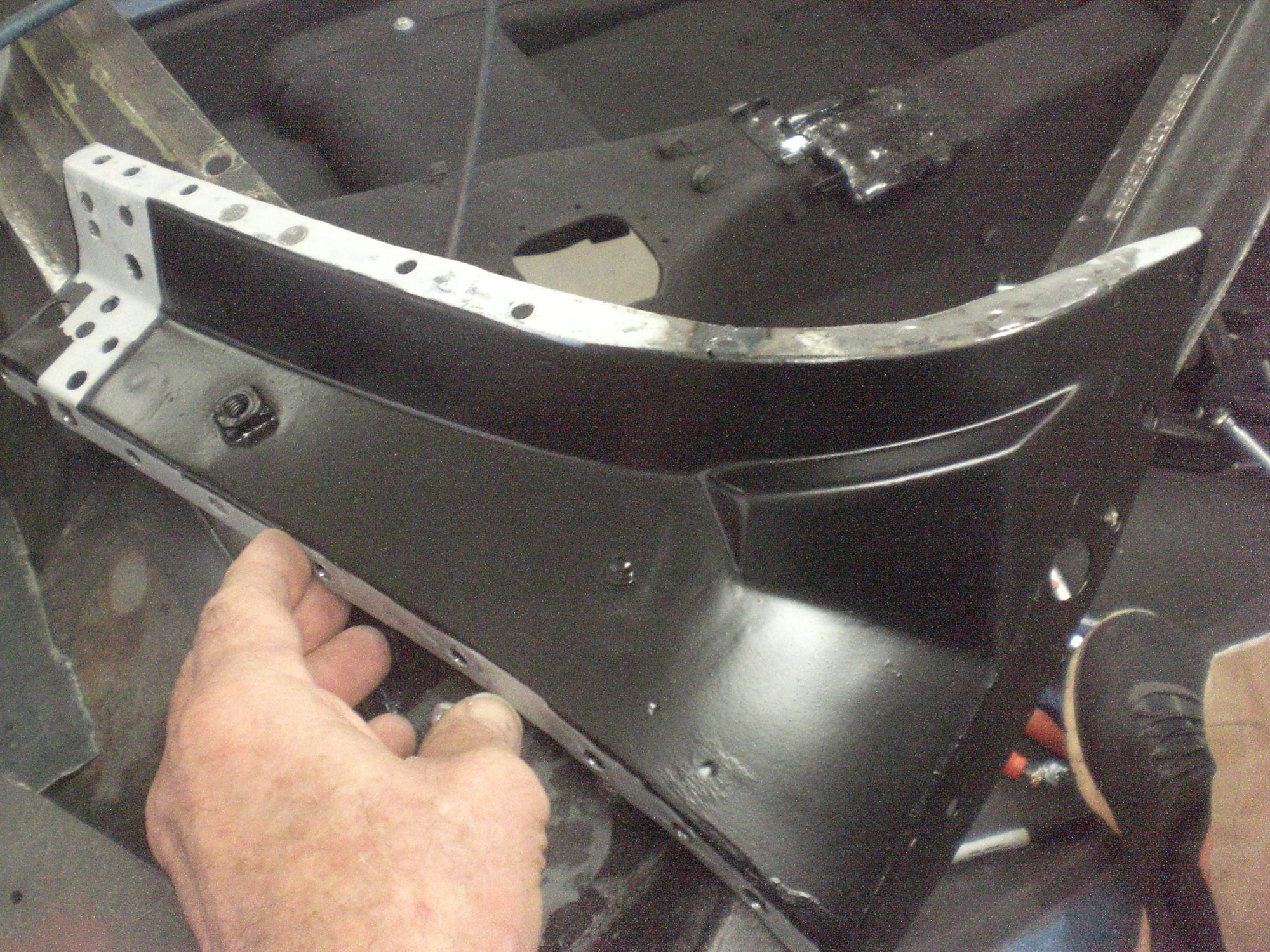 Weld-through primer was applied to flanges that were to be plug welded.  Anti-rust paint was applied to the rest of the inner corner.