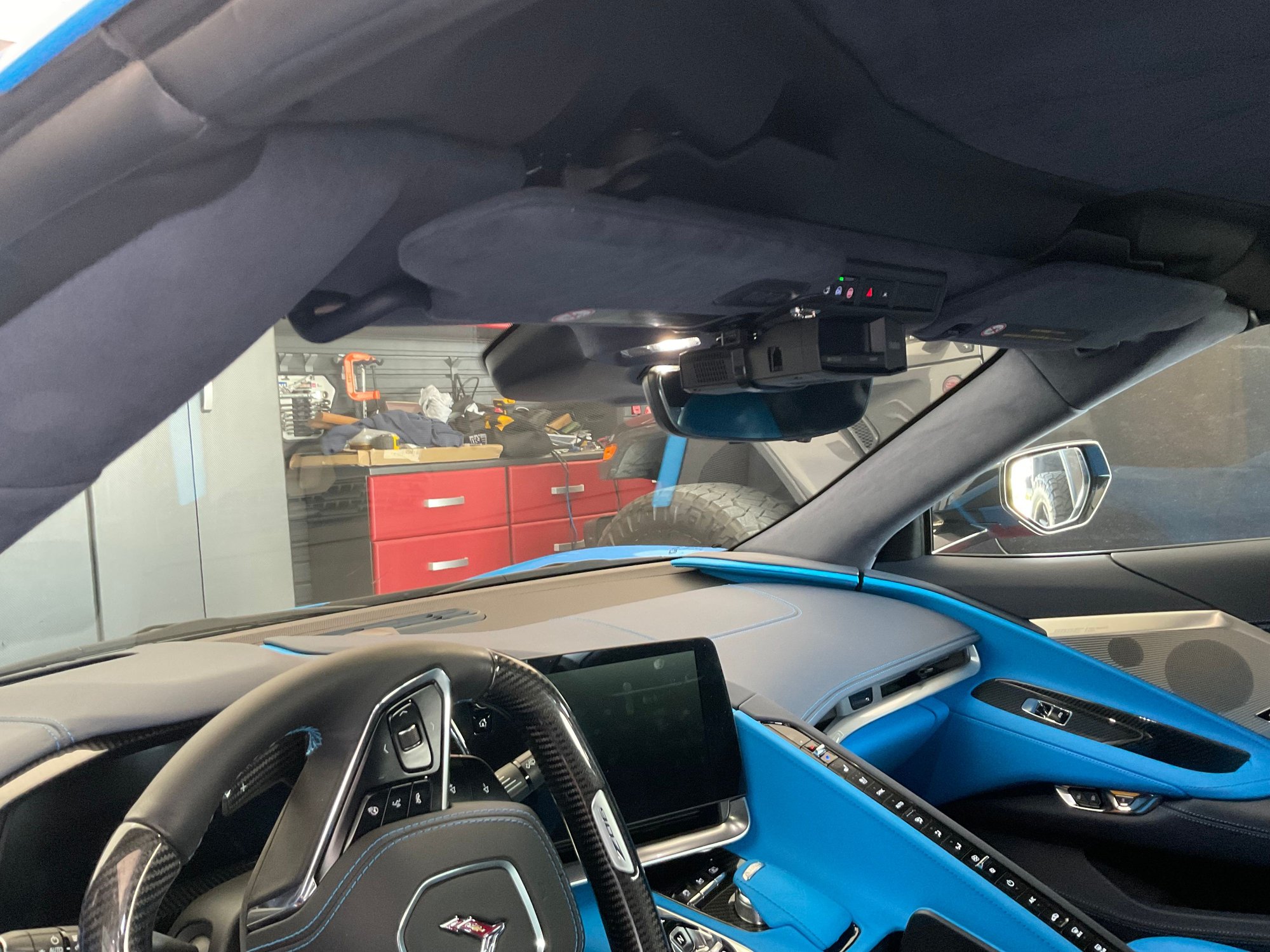 I bought a visor clip made to hold your sunglasses off Amazon for Les than $10 and used a wire tie to hold my R8 in place. It is solid and works great with zero visibility issues.