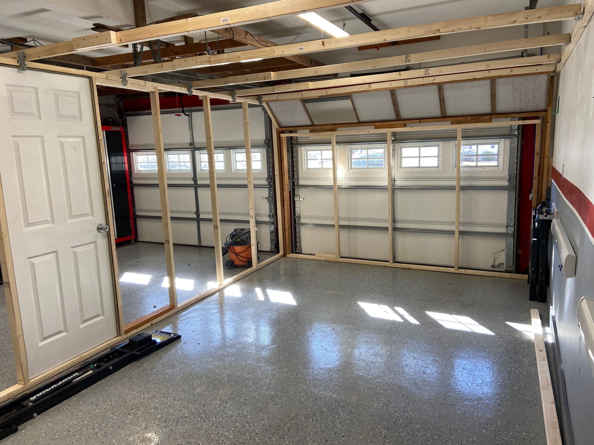 Framing it up.  The center section in front of the roll up door is removable so I can get the car in and out. 