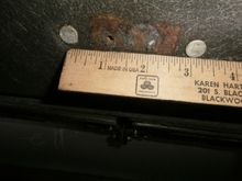3-1/8 " from rivet to rivet. You can even see where one mounting screw snapped.