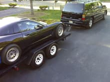 truck towing car on trailer