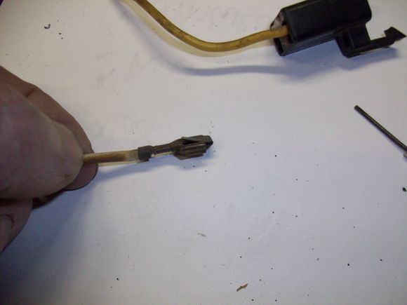 Pull the wire and lug out from the back while holding the tool down in the connector.