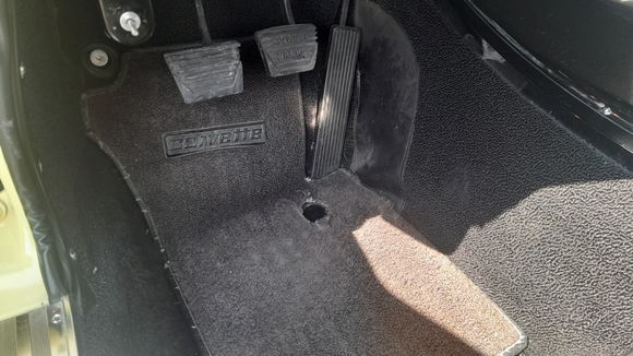 Hole in my floor mat after 80,000 miles. lol.