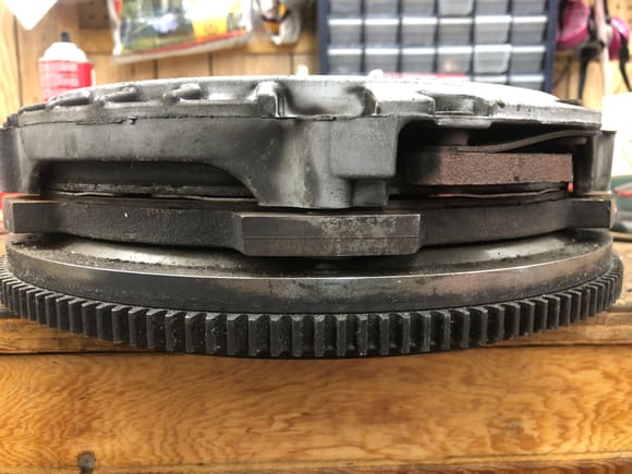 this is the worn out spring pressure plate sitting stacked with a slightly worn but still within spec clutch no bolts in it. look at how little gap there is for the pp bolts to close!!  hardly any clamping force left!!