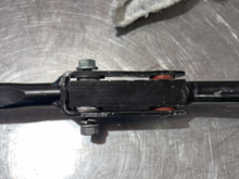 A "bushing" pressed into an oval hole in an articulating joint of the shifter rod.  Circled to the right side of the mechanism in the diagram and closest to the point where the shifter exits the cabin and goes underneath the body.