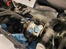 The Evo X's stock TD05-12T turbo at 110k miles. The top left hole has threads damaged by the seized nut. The top right hole, in this picture, has a temporary bolt screwed in