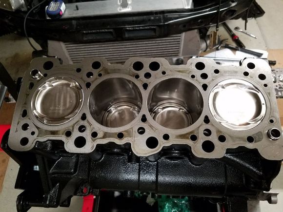 All pistons in their new (old) home.  All rings clocked properly