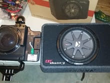 Crappy Sub on left from factory replaced by Kicker RT Comp 3 Sub off amazon