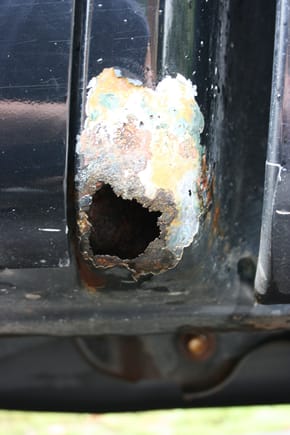 Drivers side. Its a little hard to see but you can see the rust coming through from the inside above the hole.