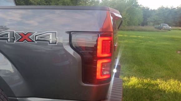 Side view of taillight, lights on, brake applied.
