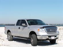 Pro-Comp 2.5&quot; leveling kit, 32X10.5&quot; tires, some exhaust work w/tips, removed 4x4 decals, undercoated rear fender wells, window tint and chrome grill insert.  Nov '08 on Navarre Beach, FL