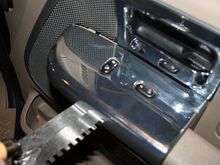 Step 1: Using a scraper or flat metal tool, gently pry up the passenger side door control panel.