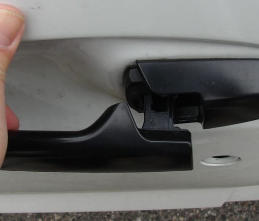 2016 Honda Fit, Canada, driver's side door handle open, looking down. The door handle bracket is black.