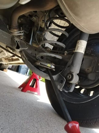 1 simple bolt on each side and the springs almost drop out on their own.   with a help of a pry bar, took less than a minute each side to pull out the rear springs