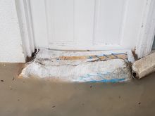 The entrance to a ground floor room after a rain storm.
