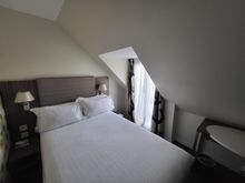 The bed takes half of the room. 