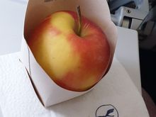 Fresh apples offered alongside chocolates.