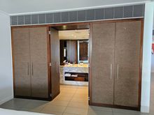 Storage space leading into bathroom