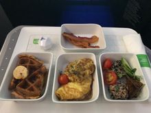 Clockwise from top: maple glazed bacon, smoked salmon salad, smoked Gouda & caramelized onion omelette, fried chicken & waffles