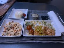 Pre-arrival meal. Shrimp salad with a side of orzo. Looks like a domestic F cold meal.