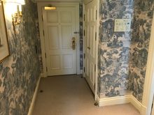 Entrance hallway with storage closet and safe inside