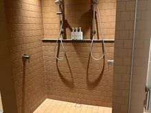 Bathroom with tub and dual-head shower.