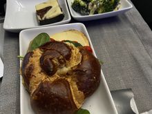 A single piece of cheese, some peppers and some hummus. 