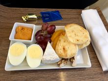 Choice of Roast Beef sandwich with chips or Protein Plate with grilled chicken strips and hummus, pita, egg, grapes, Brie.  Snack basket passed later.  Attentive and friendly service. 