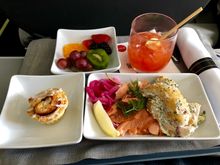 Poached salmon, fresh dill, pickled onion, lemon.  Sour cream chive potato salad. (very tasty)  Side of fruit.  Cinnamon roll.   